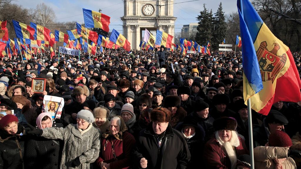 Protesters shout slogans during a large demonstration in Chisinau, Moldova, on Sunday. Photograph: Vadim Ghirda/EPA