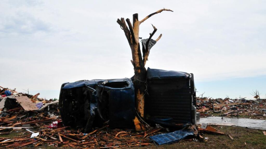 A vehicle wrapped around a tree in a neighbourhood that was in the direct path of the tornado. Photograph: Nick Oxford/The New York Times