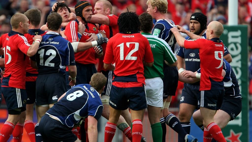 Munster forward Alan Quinlan (cap) is held back from Leinster captain Leo Cullen during the Heineken Cup semi-final won by Leinster at Croke Park in 2009. Photograph: Stu Forster/Getty Images