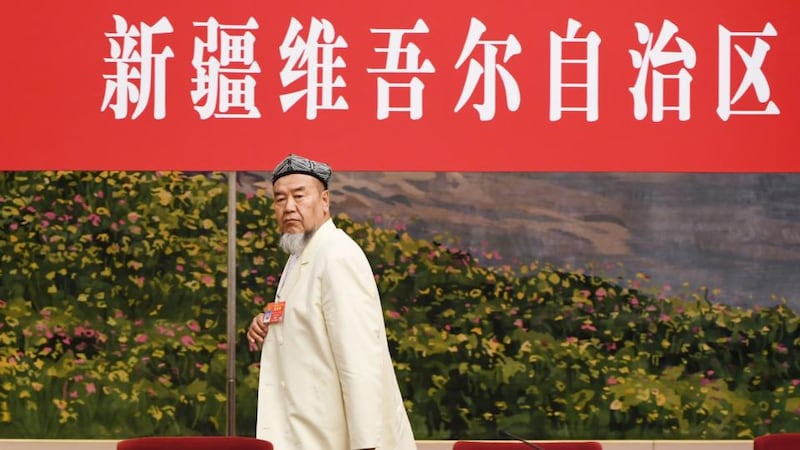 A Uighur delegate leaves the room at the end of the Xinjiang delegation meeting at the ongoing National People’s Congress at the Great Hall of the People in Beijing on March 12th. Photograph: Greg Baker/AFP/Getty