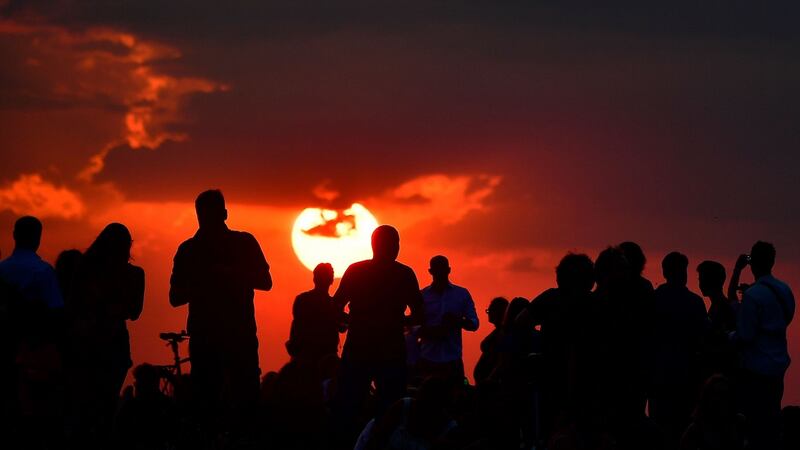 People gather as they wait for the sun to go down and the appearance of the blood moon in Berlin. Photograph: Tobias Schwatrz/AFP/Getty Images