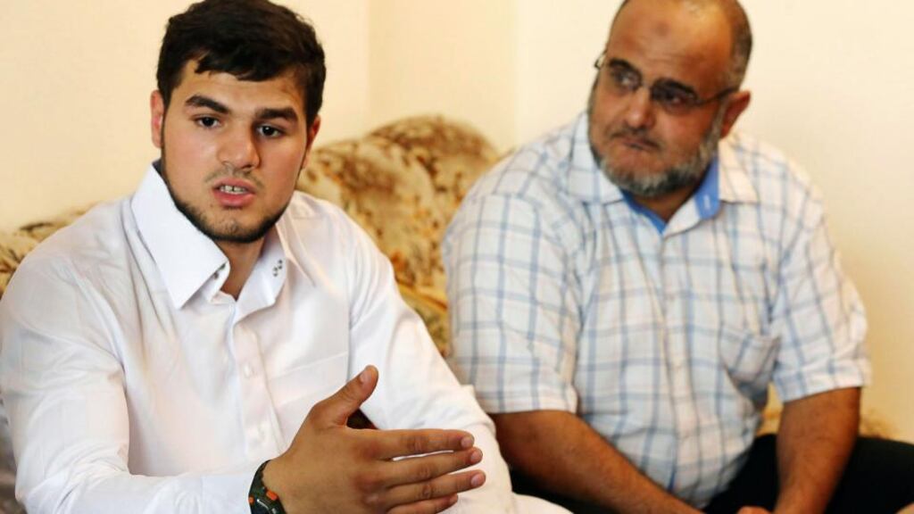 Abdullah al Ragye (L), son of Nazih al-Ragye, better known as Abu Anas al-Liby, speaks to reporters at the family home in Tripoli yesterday. Photograph: Reuters