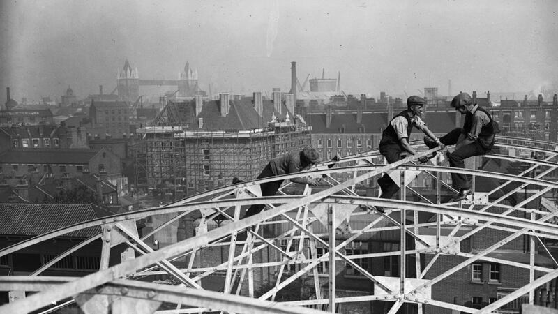 Construction workers high over London with London Bridge in the background. Photograph: Getty Images