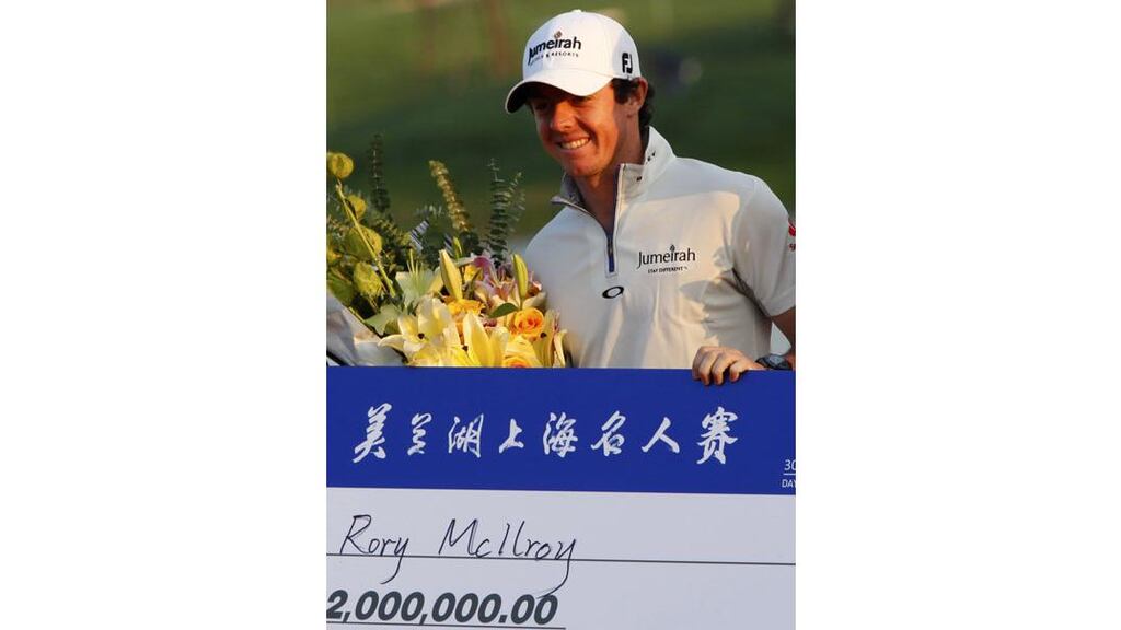 Rory McIlroy poses for photos with the winner's cheque after winning the Lake Malaren Shanghai Masters golf tournament in Shanghai, China, on Sunday Octobher 30th, 2011. - (Photograph: Aly Song/Reuters)