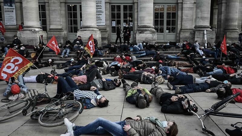 Members of workers unions of artists and technicians from the entertainment sector lay on the ground during a demonstration against what they say is inadequate and insufficient aid by the government in front of the Grand Theatre in Bordeaux, France on Friday. Photograph: Philippe Lopez/AFP