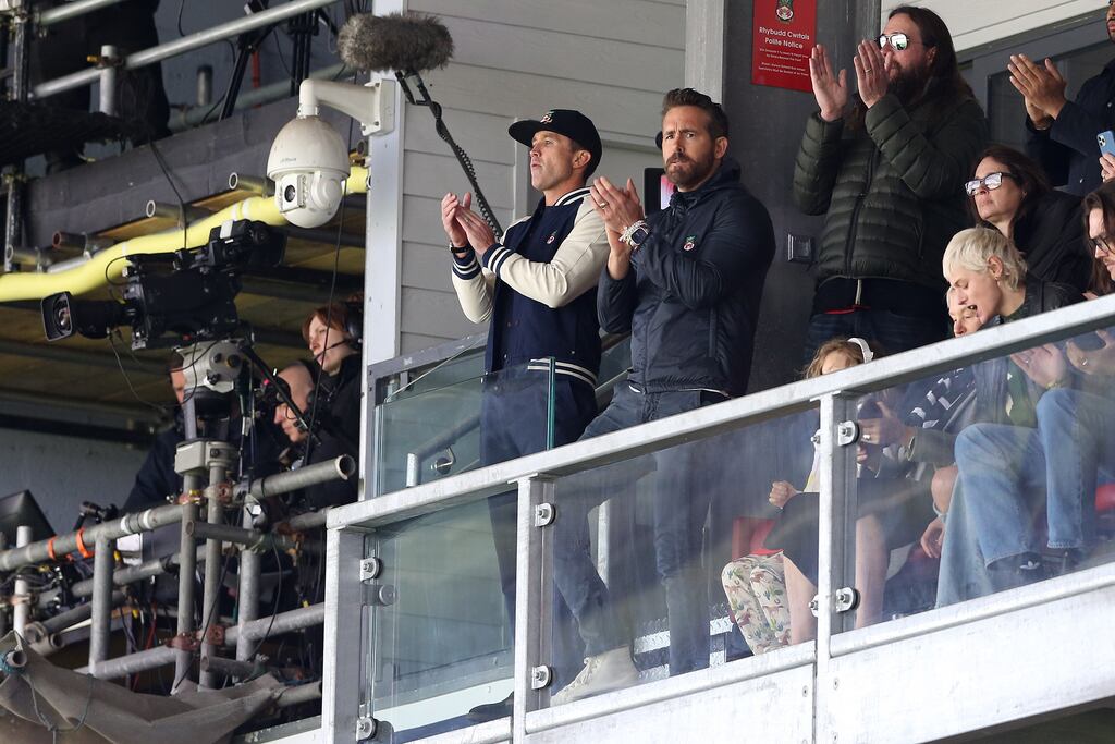 Wrexham's owners Ryan Reynolds and Rob McElhenney watch their team's win over Notts County at the Racecourse Ground. Photograph: PA