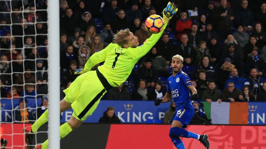 Leicester City’s Riyad Mahrez scores his side’s first goal past Huddersfield Town’s goalkeeper Jonas Lossl during the Premier League match at the King Power Stadium. Photograph: Lindsey Parnaby/AFP