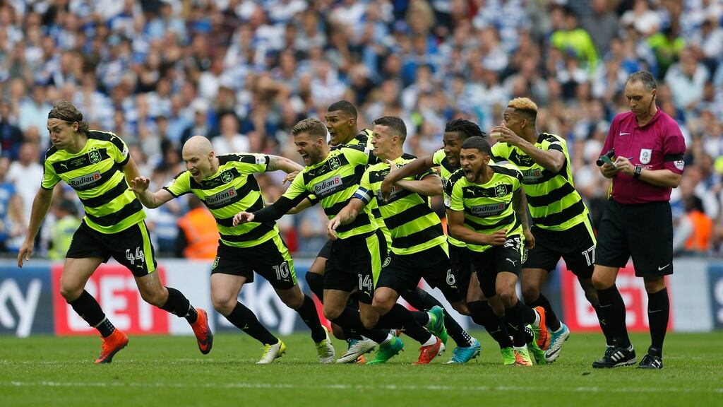 Huddersfield Town players react to the winning penalty at Wembley. Photograph: Reuters