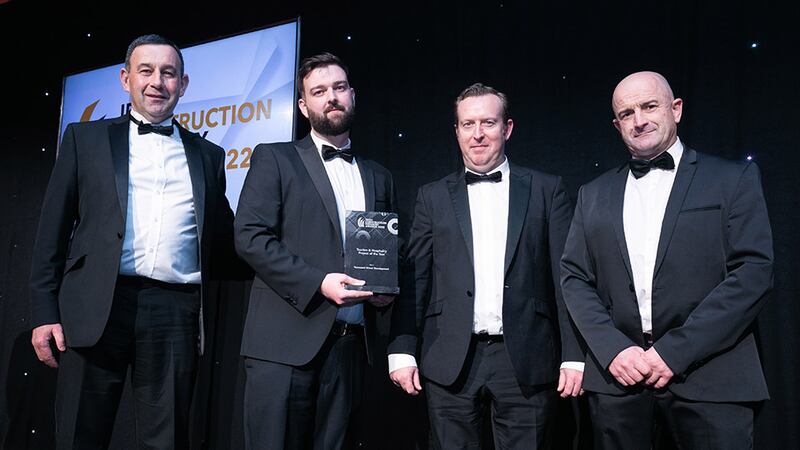 Stephen Grant, BIM manager, Petruf Consulting, presents the Tourism and Hospitality Project of the Year award to the John Paul Construction team.