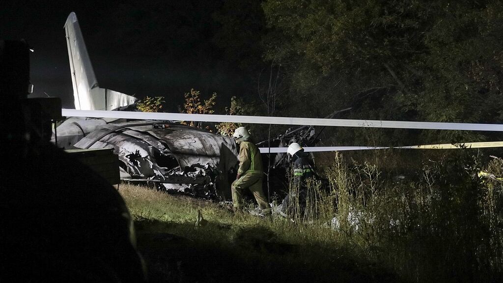 Rescuers inspect the crash site of the An-26 plane near Chuhuiv, Ukraine. Photograph: EPA