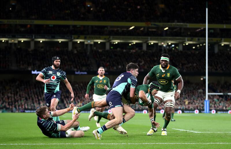 South Africa's Cheslin Kolbe is tackled by Ireland's Jimmy O’Brien and Garry Ringrose at the Aviva Stadium. Photograph: Bryan Keane/Inpho