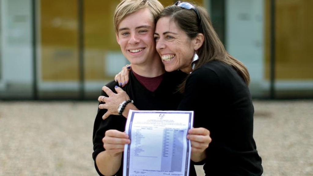 Mark Berney at Gorey Community College, Co Wexford, with his mother Nicky Deacon, holding a copy of his Leaving Cert results with 9 A1s last year. Photograph: Julien Behal
