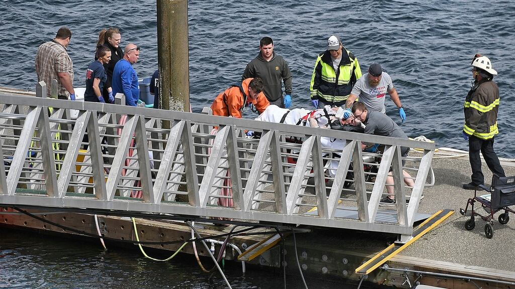 Emergency response crews transport an injured passenger to an ambulance at the George Inlet Lodge docks in Ketchikan, Alaska. Photograph: Dustin Safranek/Ketchikan Daily News/ AP