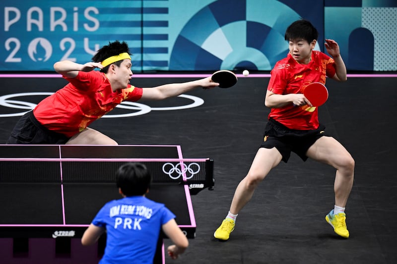North Korea's Kim Kum Yong and North Korea's Ri Jong Sik in action in the mixed doubles table tennis doubles bronze medal match against China in Paris. Photograph: Wang Zhao/AFP/ via Getty Images