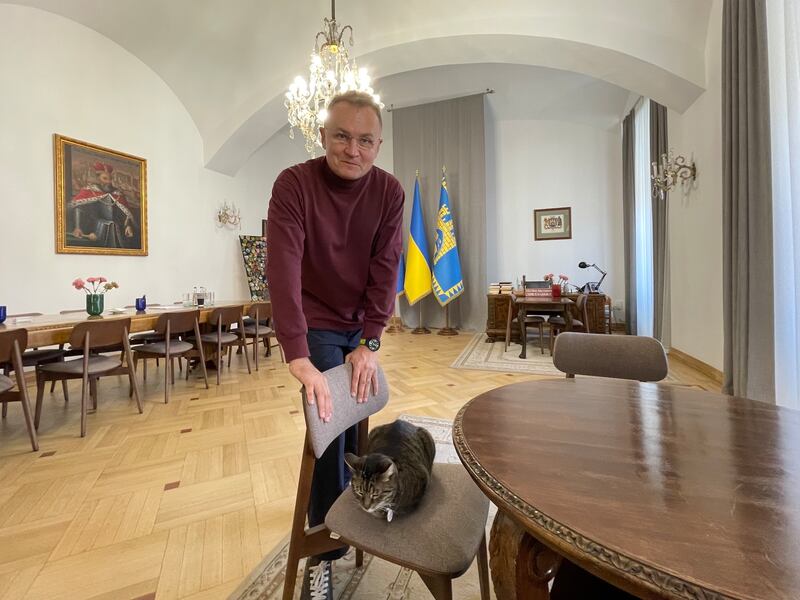 Andriy Sadovyi with Levchyk, a cat who lives in the city hall and has 25,000 followers on Instagram. Photograph: Daniel McLaughlin
