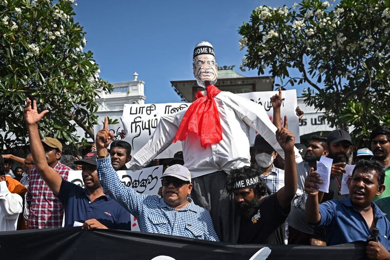 Demonstrators take part in a procession carrying an effigy of Ranil Wickremesinghe during a protest in front of the Fort railway station in Colombo on Tuesday. Photograph: Arun Sankar/AFP via Getty Images