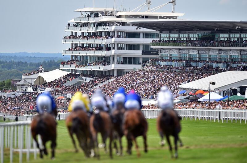 Runners and riders take the corner into the straight at the iconic Epsom Derby in Surrey. Photograph: Glyn Kirk/AFP via Getty Images