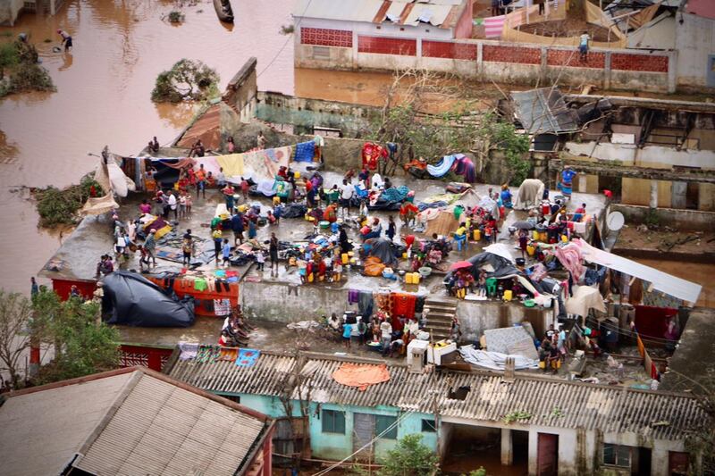 TOPSHOT - People gather on the roof of a house submerged by floods in Buzi on March 20th. Photograph: Adrien Barbier/AFP/Getty