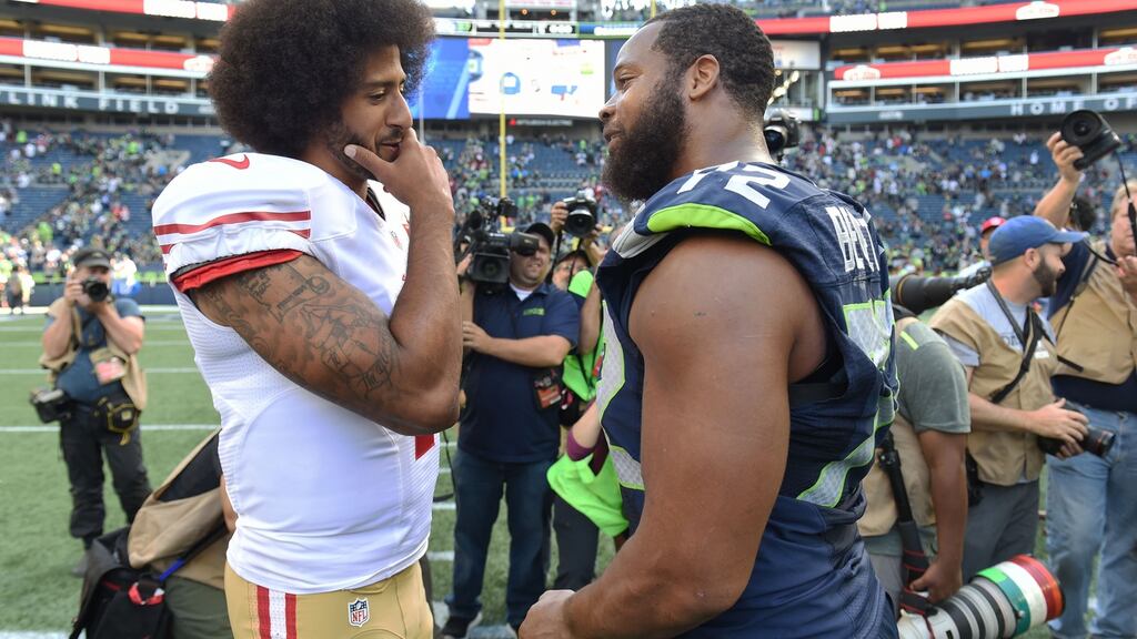 Seattle’s Michael Bennett (right), who sat out the US anthem on Sunday, with 49ers quarterback Colin Kaepernick in 2016. Kaepernick has yet to be signed since his anthem protest. Photograph: Steve Dykes/Getty Images.