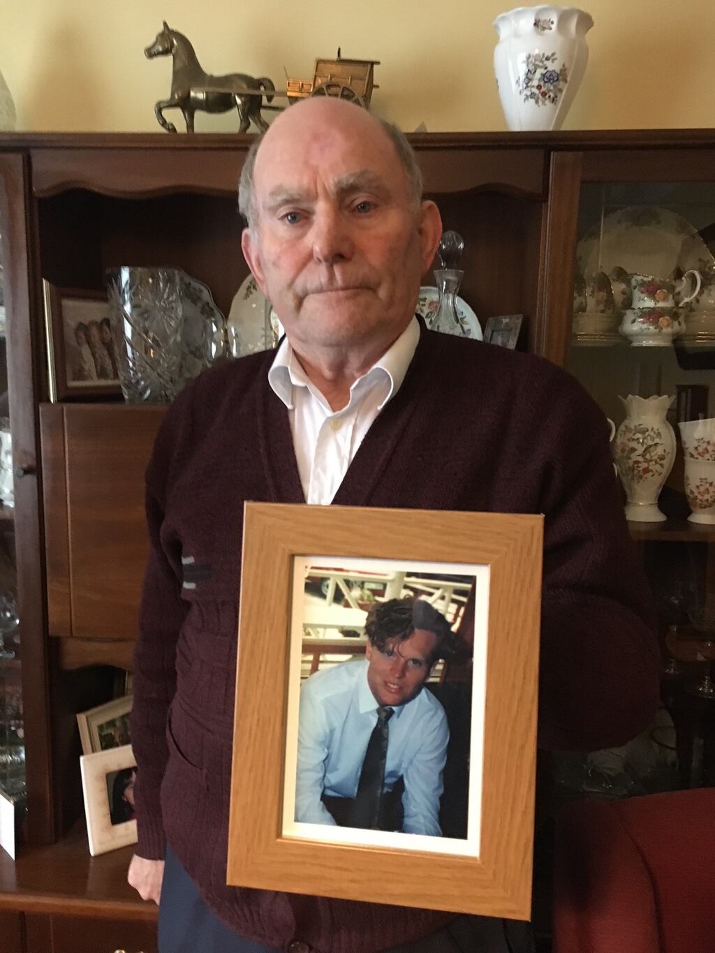 Denis Walsh snr (83), in Caherdavin, Co Limerick, holding a photo of his deceased son Denis Walsh jnr.