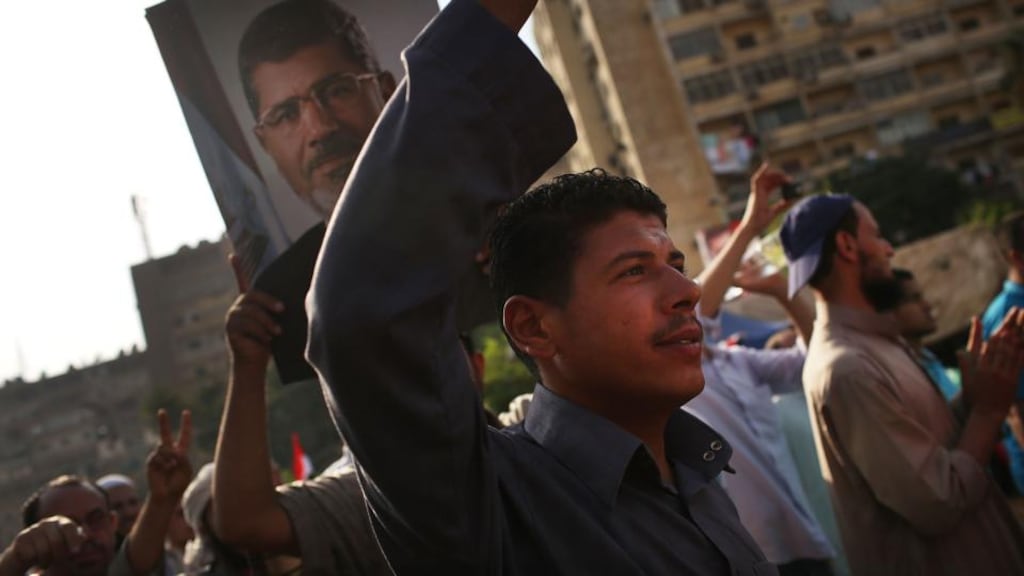 Supporters of Mohamed Morsi rally yesterday near where more than 50 people were purported to have been killed by members of the Egyptian military and police in early morning clashes in Cairo. Photograph: Spencer Platt/Getty Images