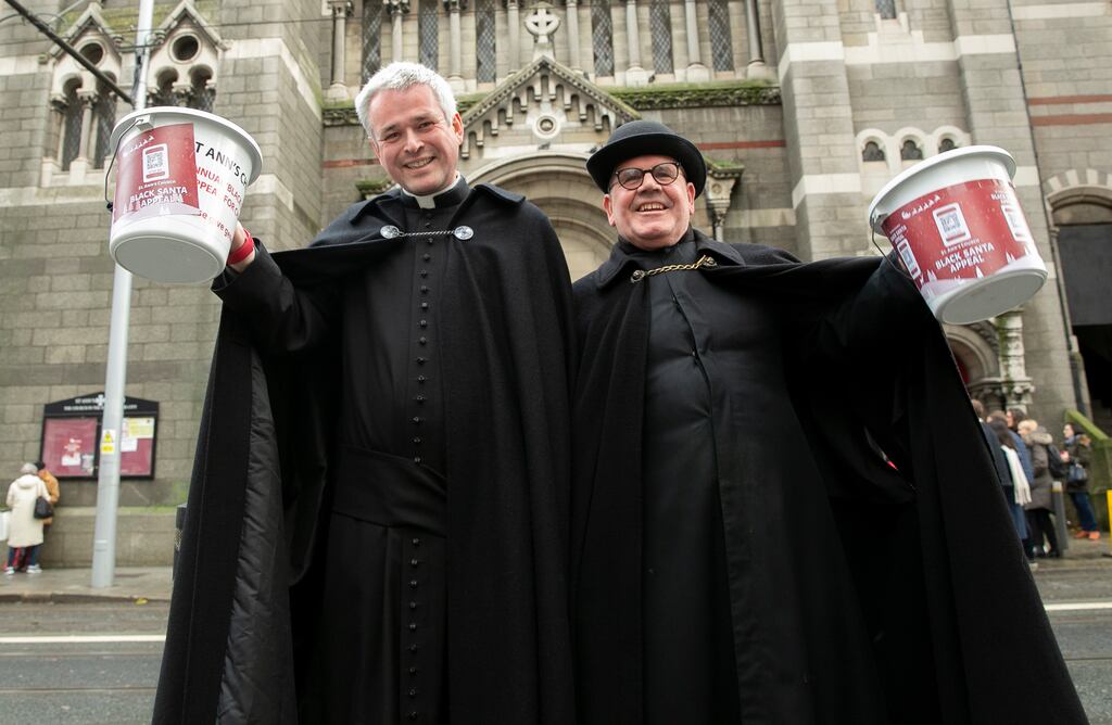 Canon Paul Arbuthnot and church caretaker Fred Deane during the Black Santa Appeal at St Ann’s Church on Dawson Street, Dublin. Photograph: Gareth Chaney/Collins Photos