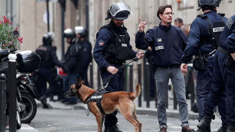 French police secure the street where a man has taken people hostage at a business in Paris, France. Photograph: Benoit Tessier/Reuters.