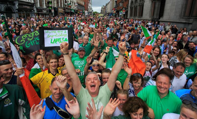 HOCKEYING FOR POSITION: Hockey fans celebrate amid a homecoming party for the Irish Hockey team on Dame Street, Dublin, after their silver medal placing in the Hockey World Cup in London. Photograph: Gareth Chaney/Collins