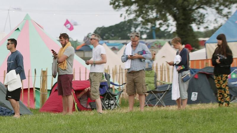 Glastonbury: the former shadow chancellor Ed Balls (third right) and his wife, Yvette Cooper (second right), queue for the showers at Worthy Farm. Photograph: Yui Mok/PA Wire