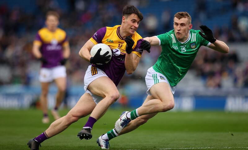 Wexford's Pairic Hughes in action againt Limerick's Killian Ryan during the Division 4 final at Croke Park on Saturday. Photograph: Ryan Byrne/Inpho