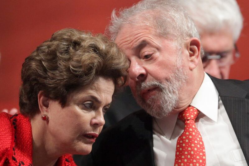 Brazil’s former president Luiz Inacio Lula da Silva talks with ousted president Dilma Rousseff. Photograph: AP