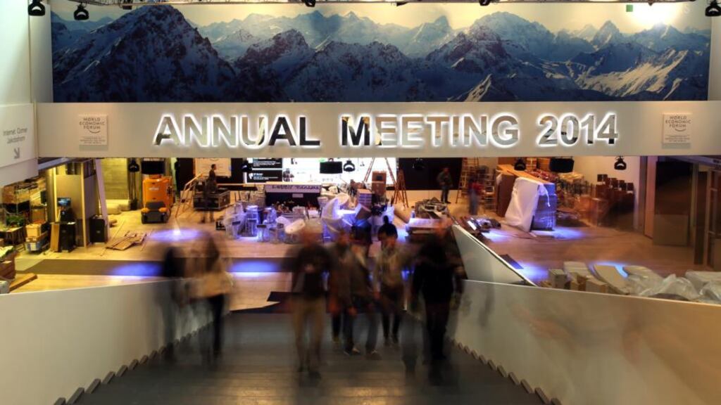 People move through the main hall of the Congress Center ahead of the World Economic Forum 2014 in Davos, Switzerland. Photographer: Simon Dawson/Bloomberg