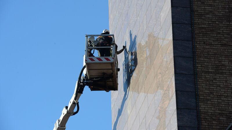 The statue being removed from the Treasury Building in Dublin’s Grand Canal Street Lower. Photograph: Alan Betson