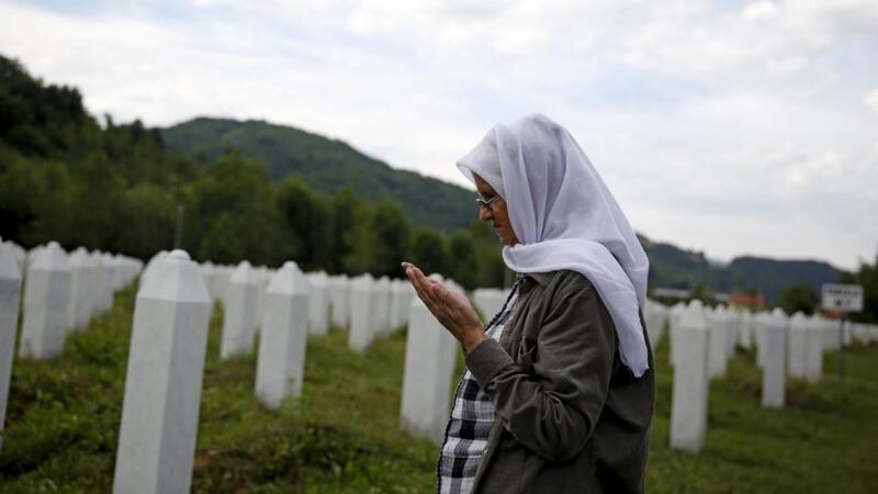 Hajra Catic prays near the grave of her husband in Potocari near Srebrenica. Photograph: Dado Ruvic/Reuters