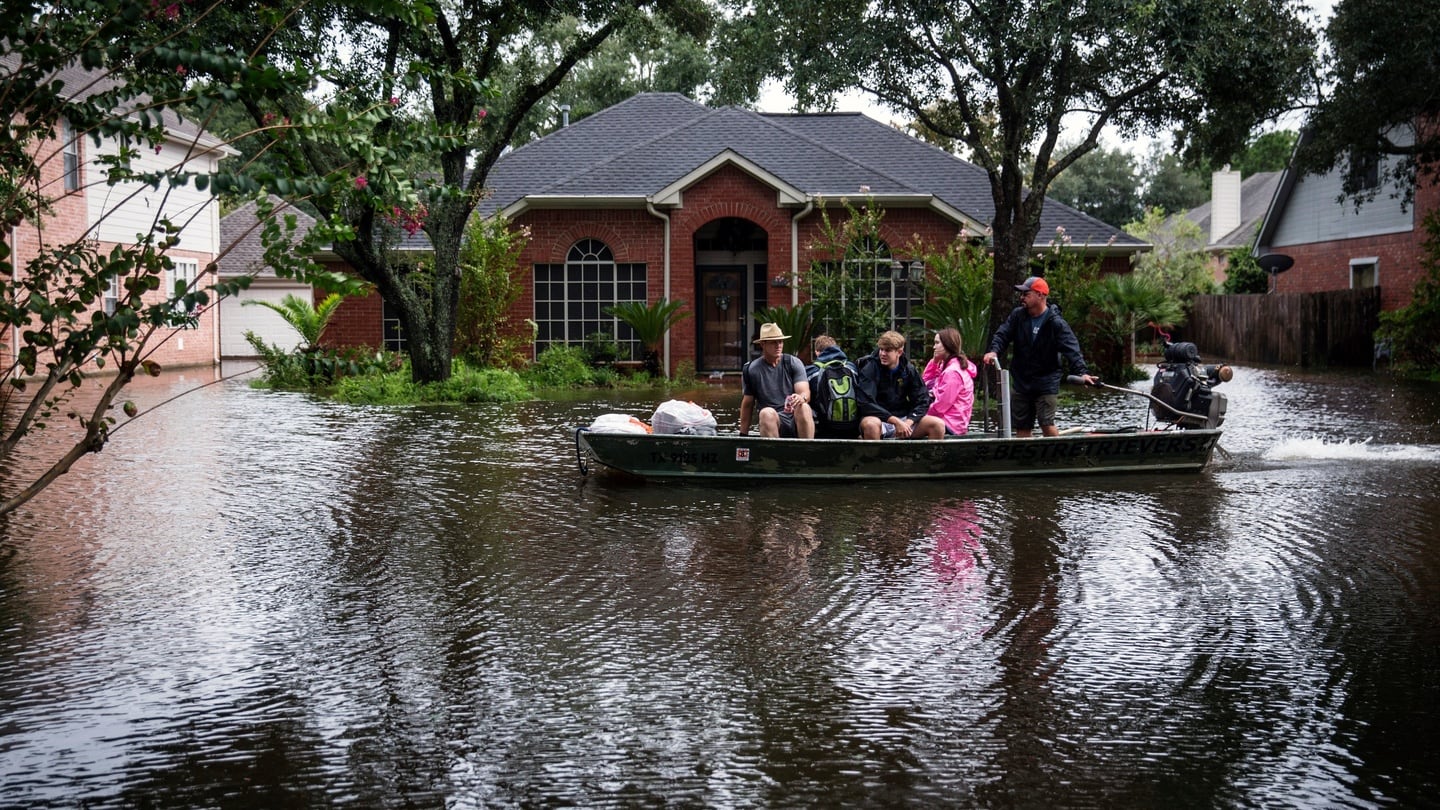 A volunteer search-and-rescue team evacuates Rodney Graham from a Houston neighbourhood, in Texas, the US. Photograph: Andrew Burton/The New York Times