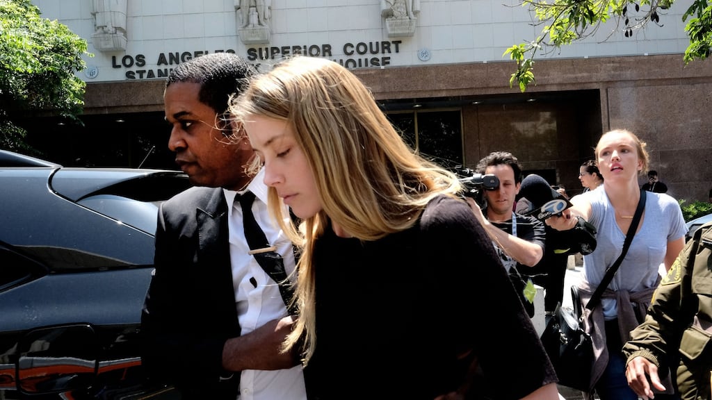 Actor Amber Heard leaves Los Angeles superior court after giving a sworn declaration that her estranged husband Johnny Depp threw her phone at her during a fight on Saturday. Photograph: Richard Vogel/AP Photo