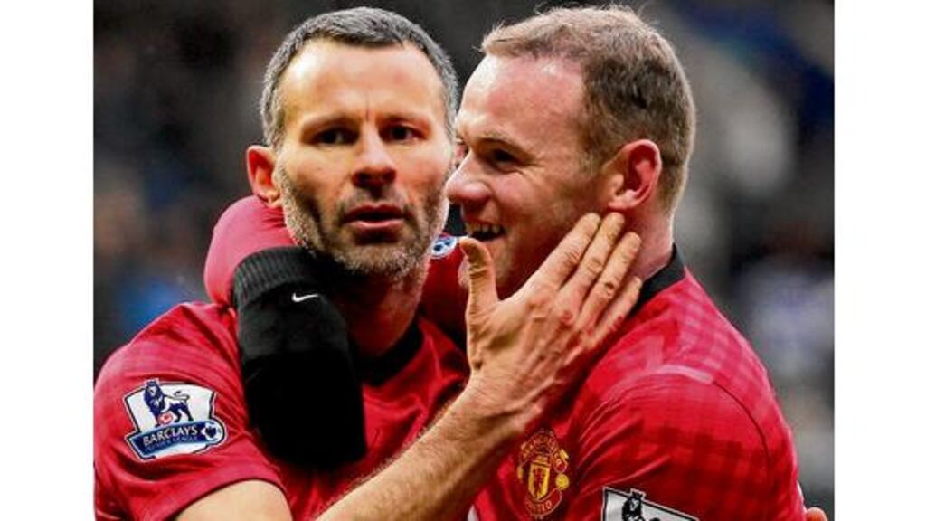 Manchester United's Ryan Giggs celebrates with Wayne Rooney after scoring United's second goal against QPR.