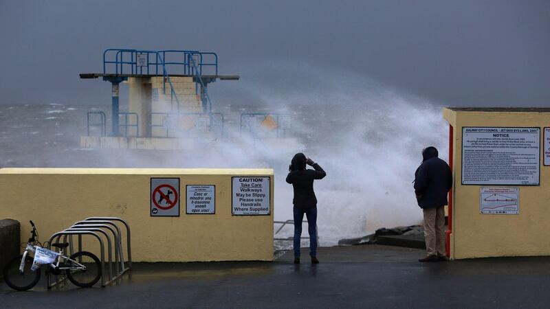 Walkers look out to sea at Blackrock in Salthill, Galway on Sunday as Storm Atiyah arrived. Photograph: Joe O’Shaughnessy