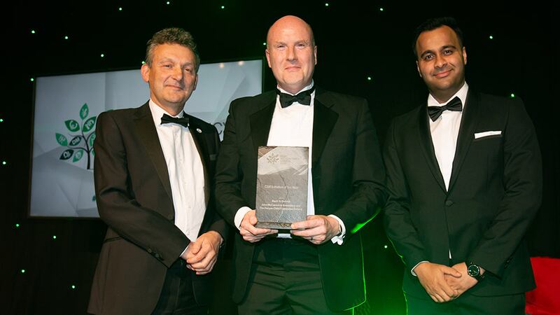 Anthony Doherty, awards judge, presents the CSR Initiative of the Year award to John McCarrick and Sahil Sarin, John McCarrick & Associates.