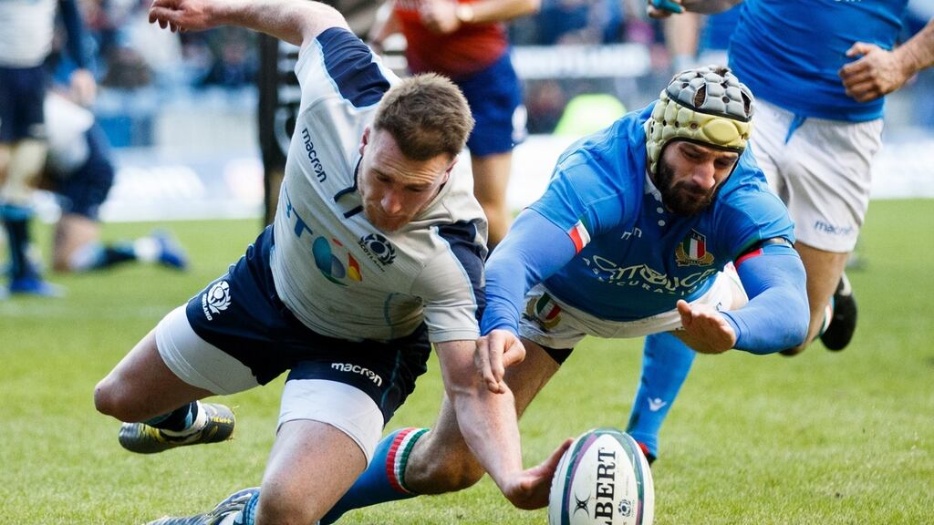 Scotland’s Stuart Hogg scores a try despite the challenge by Angelo Esposito of Italy during their Six Nations match on Saturday. Photograph: Robert Perry/EPA