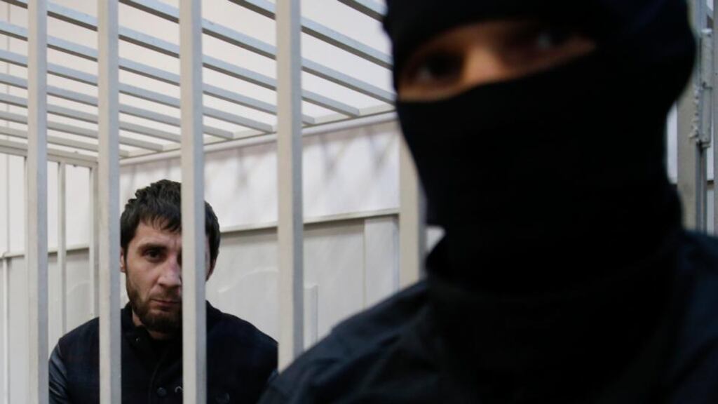 Zaur Dadayev, who is charged with involvement in the murder of Russian opposition figure Boris Nemtsov, looks out from a defendants’ cage inside a court building in Moscow, this week. Photograph: Tatyana Makeyeva/Reuters
