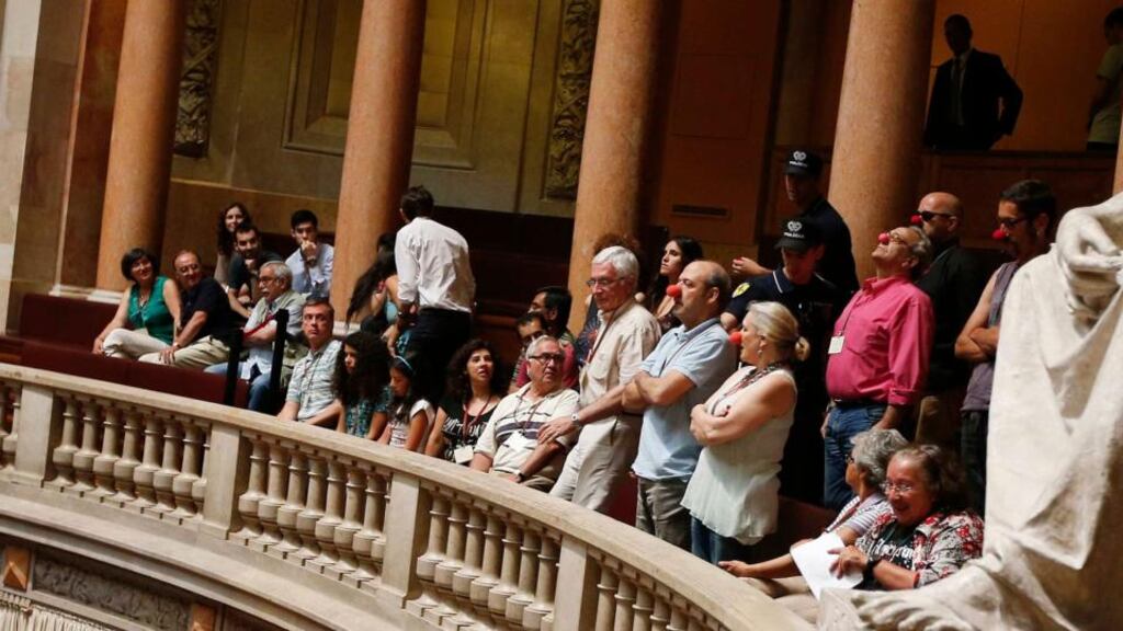 Members of the public wear red clown noses ahead of a vote on a motion of confidence on prime minister Pedro Passos Coelho’s government. Photograph: Rafael Marchante/Reuters.