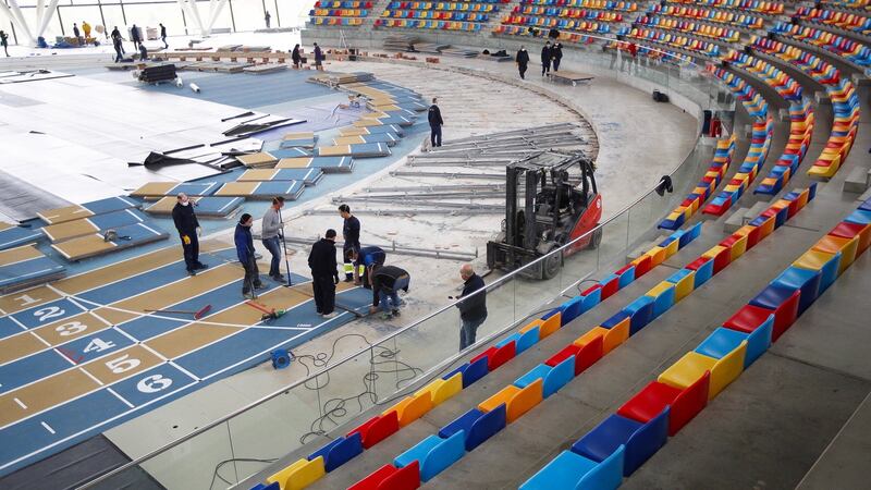 Workers dismantle the Catalunya Indoor Athletics Track during preparations to set up a temporary hospital in  in Sabadell, Barcelona, on Tuesday. Photograph: Alejandro Garcia/EPA