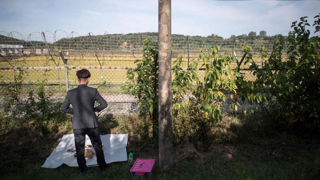 A refugee prepares to perform a ceremonial offering to relatives in North Korea, near the Demilitarised Zone. Photograph: Ed Jones/AFP/Getty Images