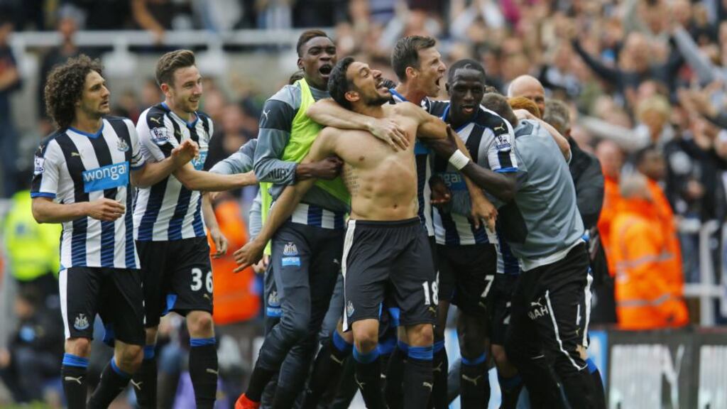 Jonas Gutierrez is mobbed by his teammates after his goal virtually guaranteed Newcastle’s Premier League survival. Photograph: Reuters