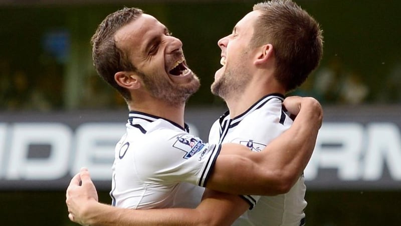 Tottenham Hotspur’s Gylfi Sigurdsson (right) celebrates with-team mate Roberto Soldado after scoring his second goal in the 2-0 Premier League victory over Norwich City at White Hart Lane. Photograph: Dylan Martinez/Reuters.
