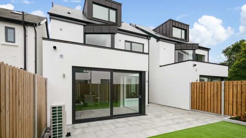 Back garden is accessed through large sliding doors. It is laid out in artificial lawn and has a northern aspect and a side entrance