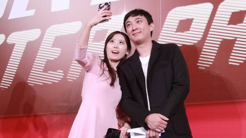 Wang Sicong poses for a selfie with a fan: the son of Wanda chairman Wang Jianlin posted pictures on social media of his dog wearing two gold Apple watches. Photograph: ChinaFotoPress/Getty Images