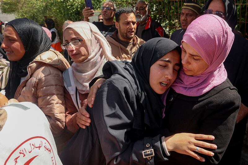 Relatives mourn during the funeral procession in Khan Younis, Gaza, for the 15 Palestinian rescue workers killed by Israeli forces las month. Photogtaph: Eyad Baba/AFP via Getty Images
