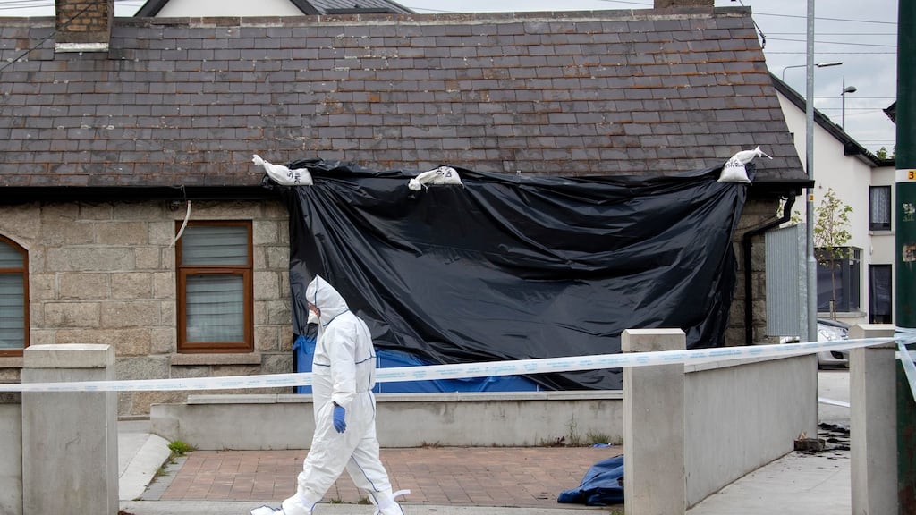 Gardaí at the scene of a house fire in Bluebell in which a man’s body was found. Photograph: Colin Keegan/Collins Dublin